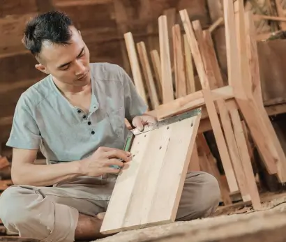 Man crafting wooden furniture piece