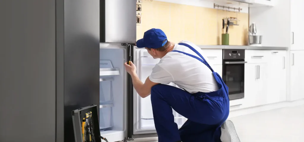 Technician repairing a refrigerator